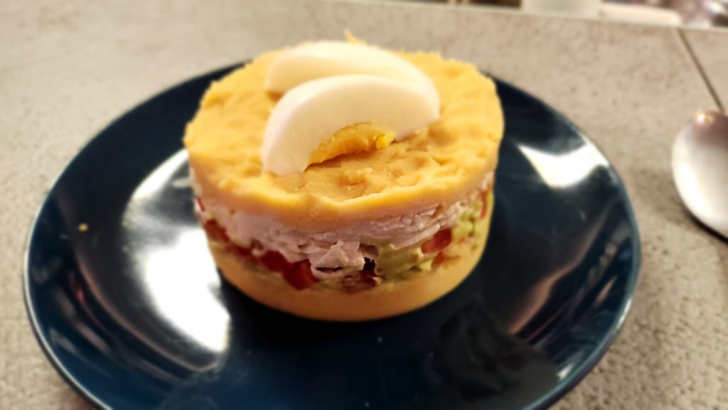 Close-up photograph of a Peruvian Causa dish  made by Ada