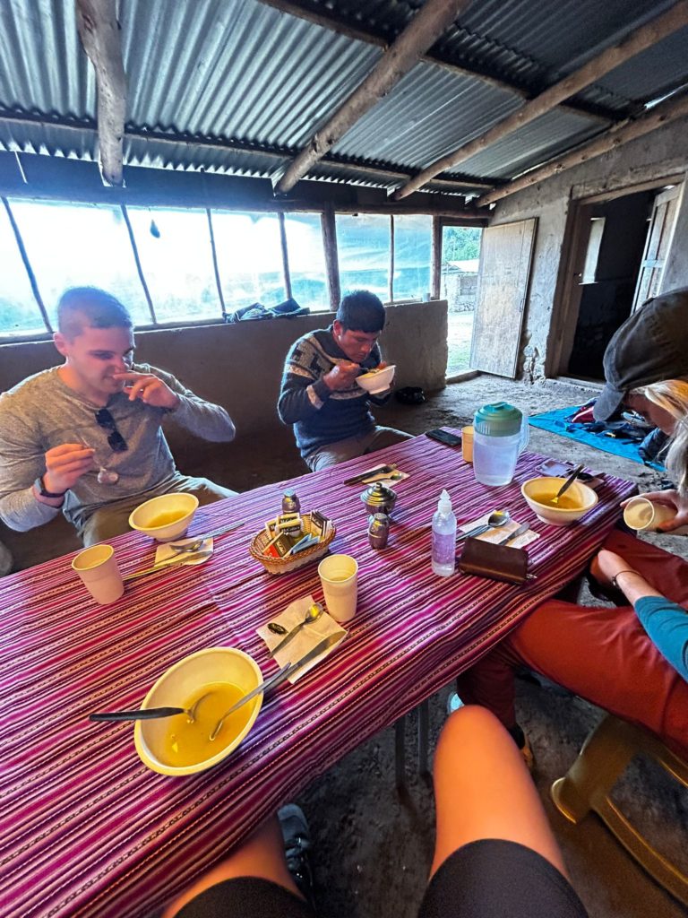 Photo of Ada's hiking companions on the Lares Trek, sitting at a colorful table for lunch.