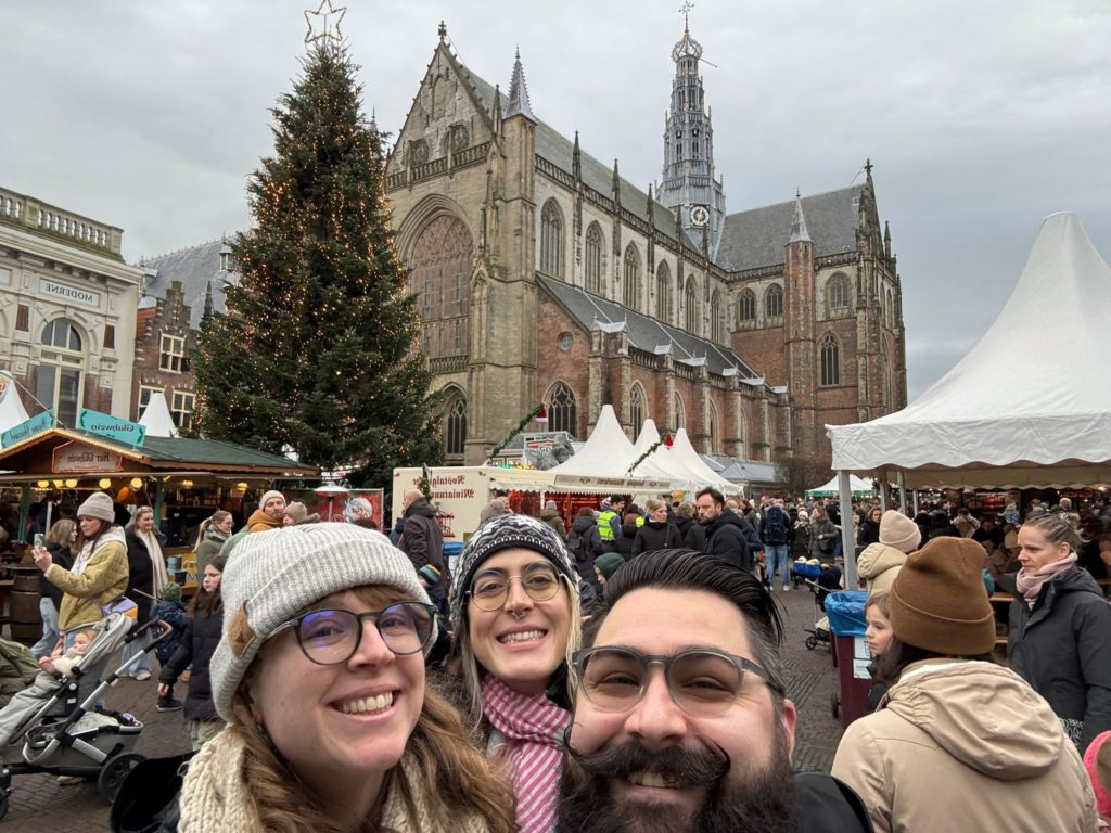 Ada, Allison, and Brandon, in front of a large Christmas Tree in the center of the market in Haarlem, NL