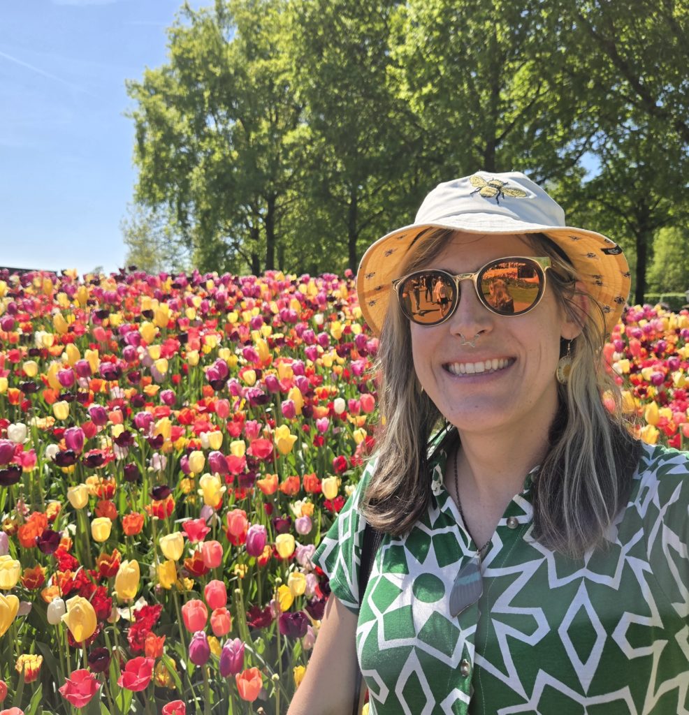 Photo of Ada in front of a hill of multicolored tulips