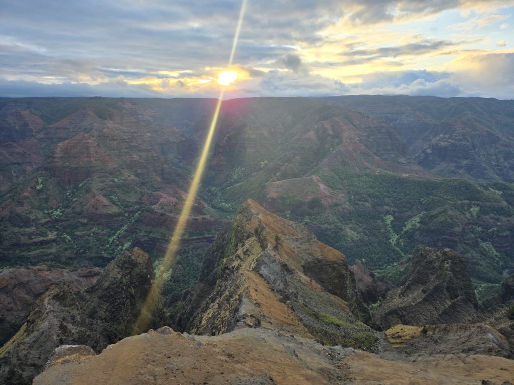 Photo of a sunrise over the Waimea Canyon